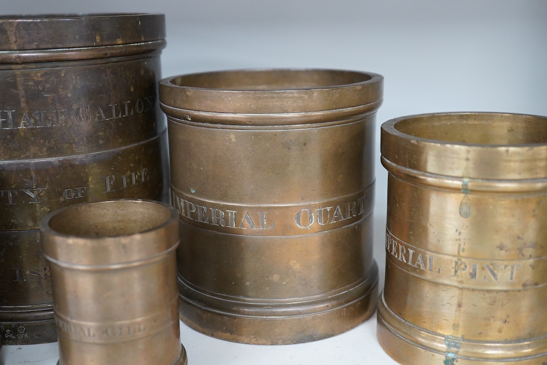 A set of seven early 20th century County of Fife official measures, comprising; a standard gallon, diameter 19.5cm, height 18.5cm, Imperial half gallon, Imperial quart, Imperial pint, Imperial half pint, Imperial gill, I